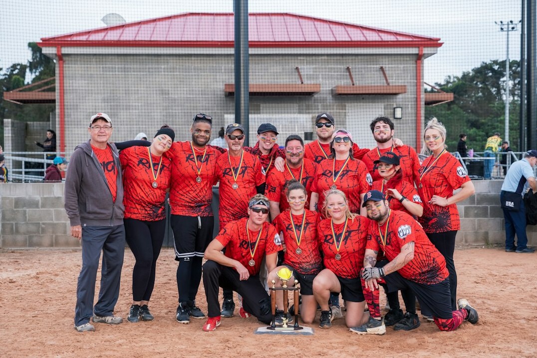Group photo of a professional team standing together in an office
